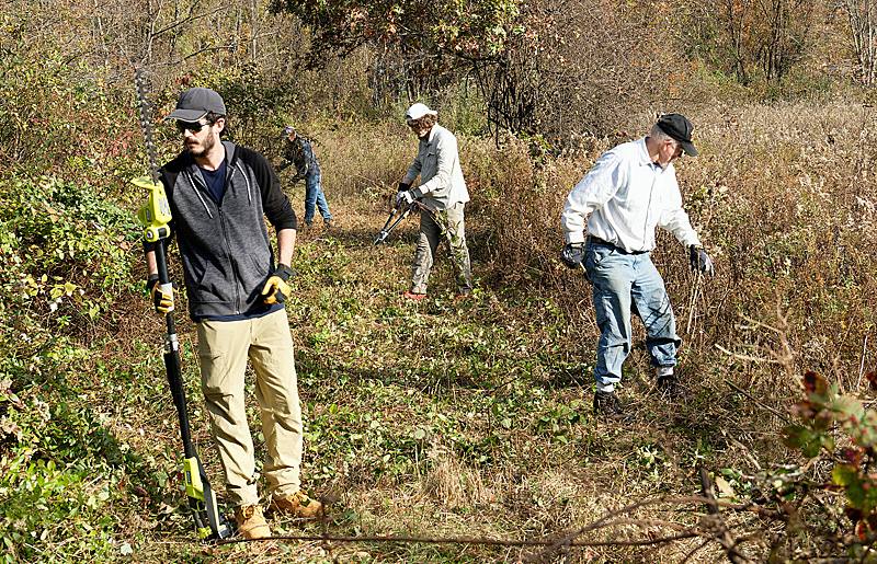 Volunteers work on clearing new path